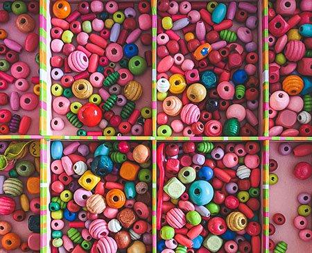 Assorted beads and materials in a tray